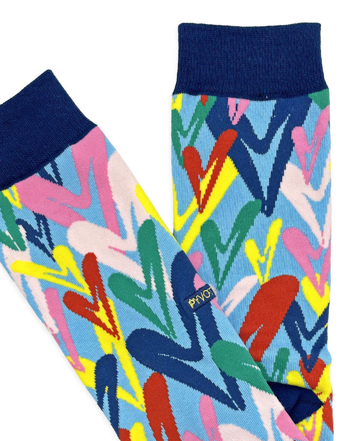 Abstract pattern crew socks with navy cuff; colorful geometric shapes and lines