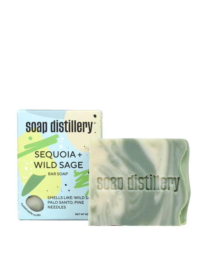 Bar soap with green marbled swirl beside soap distillery carton box