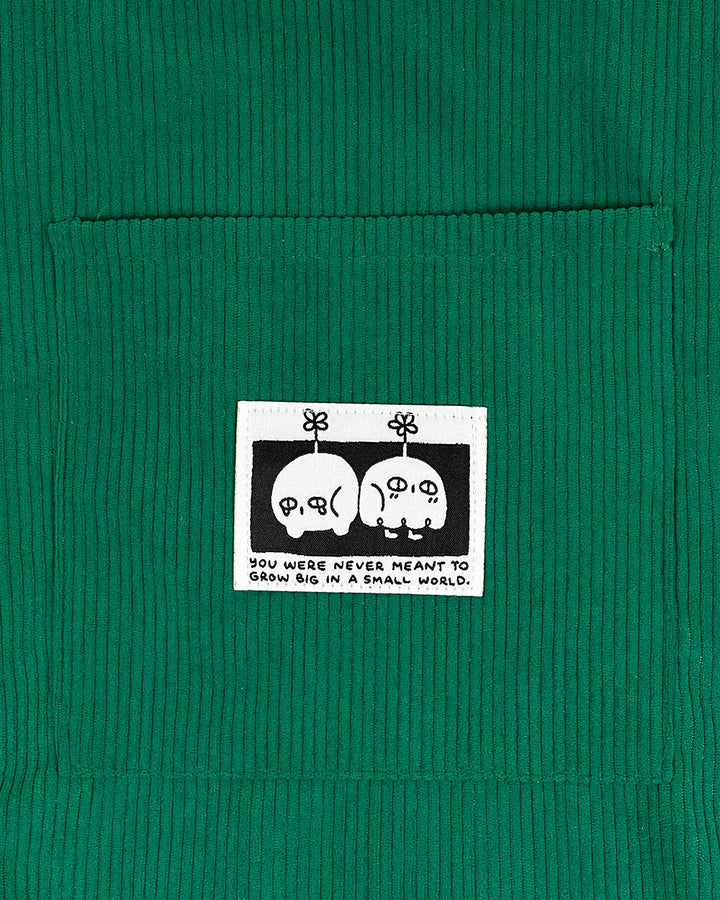 Green corduroy tote bag with character patch and top panel label