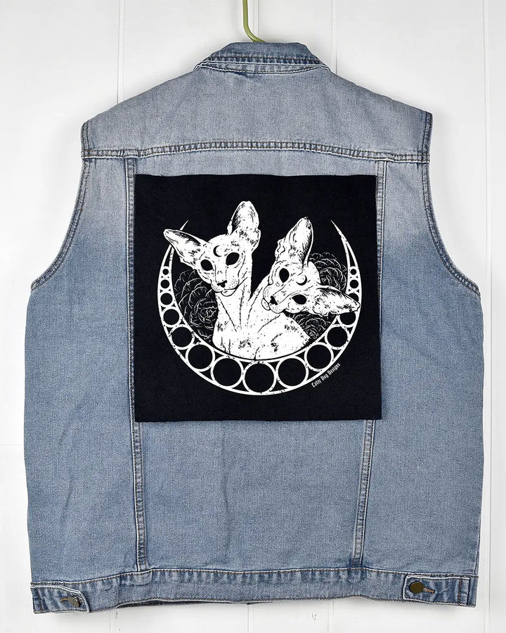 Black cat-illustration back patch displayed on the back of a denim vest