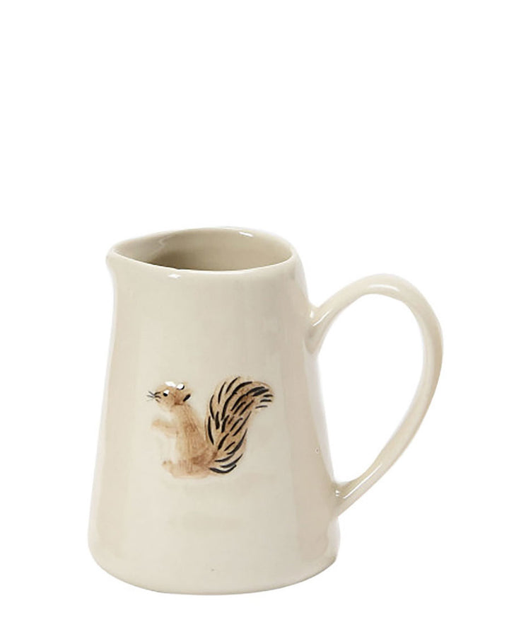 Cream ceramic squirrel creamer pitcher with curved handle, animal illustration on front