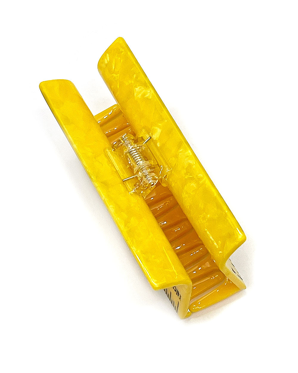 Yellow ruler hair claw clip with open prongs and spring hinge