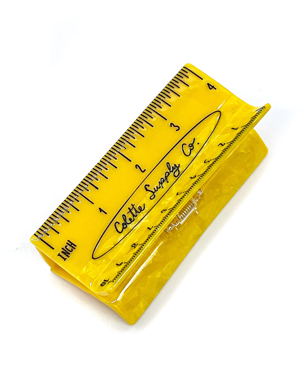 Yellow ruler-style hair claw clip with measurement markings
