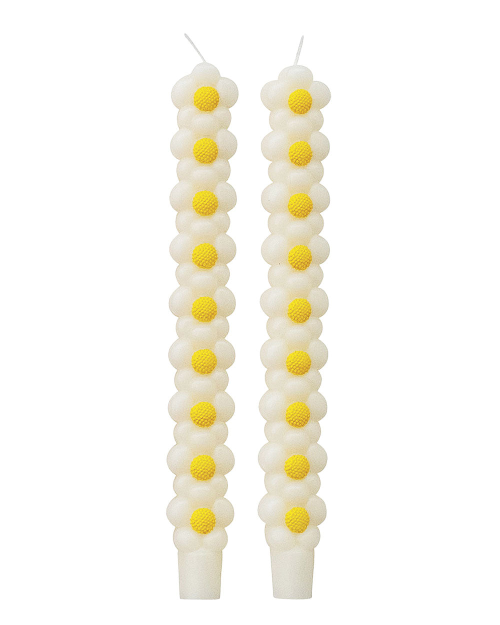 Pair of white taper candles with stacked daisy flowers and yellow centers
