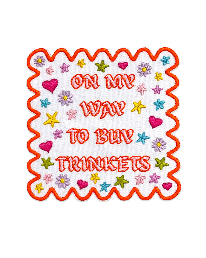 Orange zigzag border fabric patch with colorful stars and On My Way To Buy Trinkets text