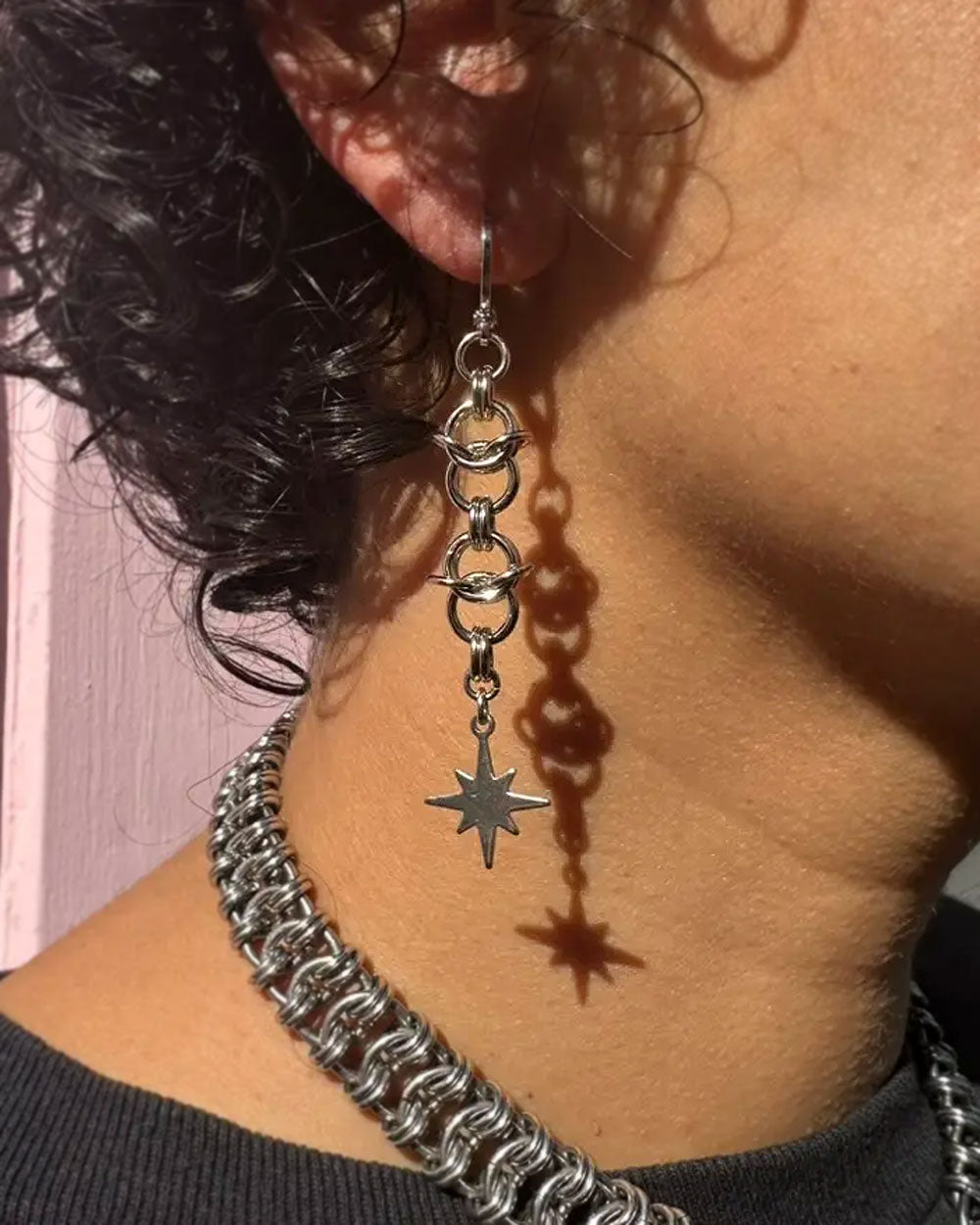 Cosmic starburst earrings with hoop, chain links, and starburst charms