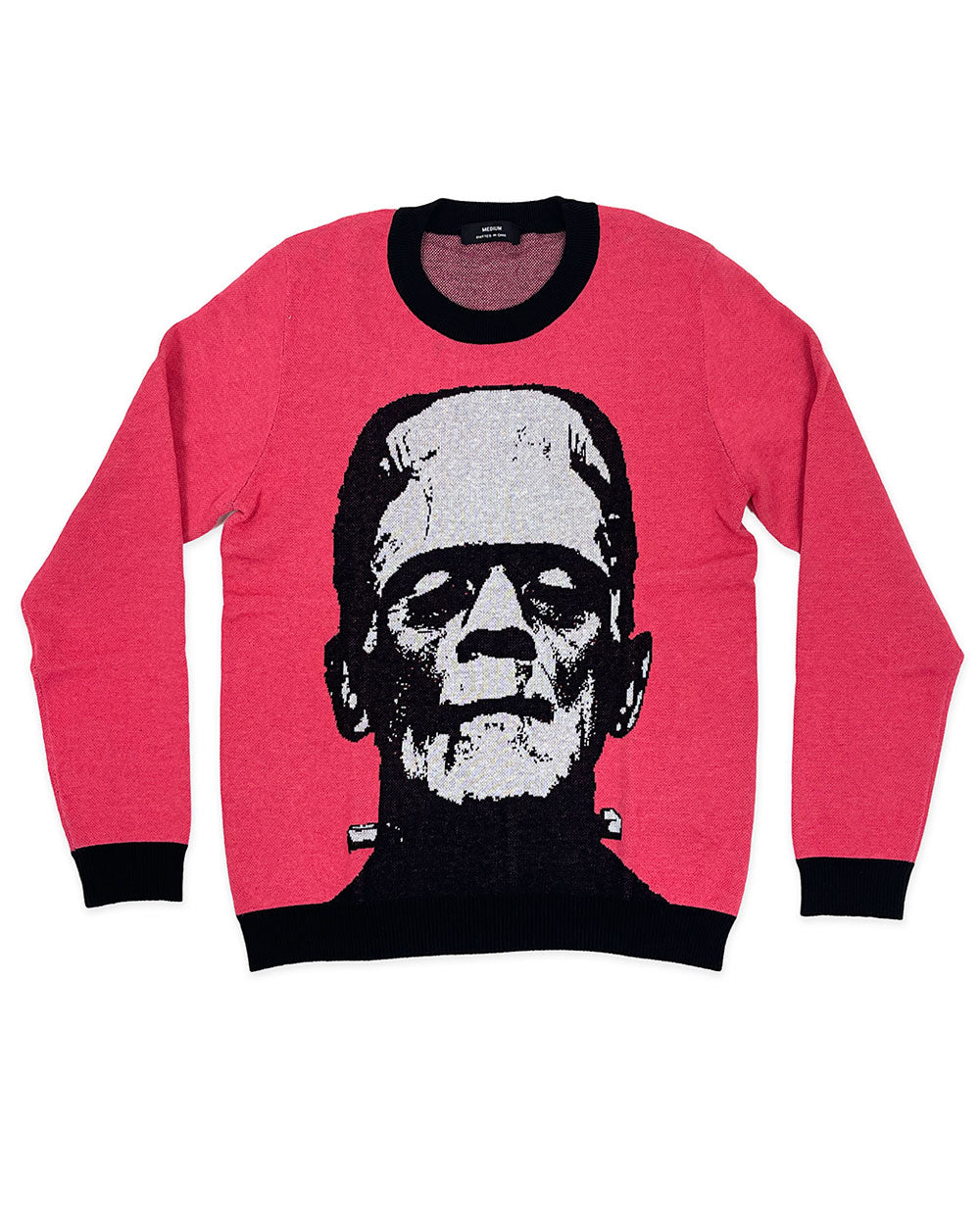 Pink unisex crewneck knit sweater with black trim and Frankenstein skull graphic