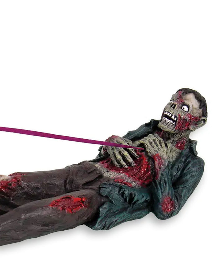 Zombie incense holder: teal corpse figure lying down with purple incense stick