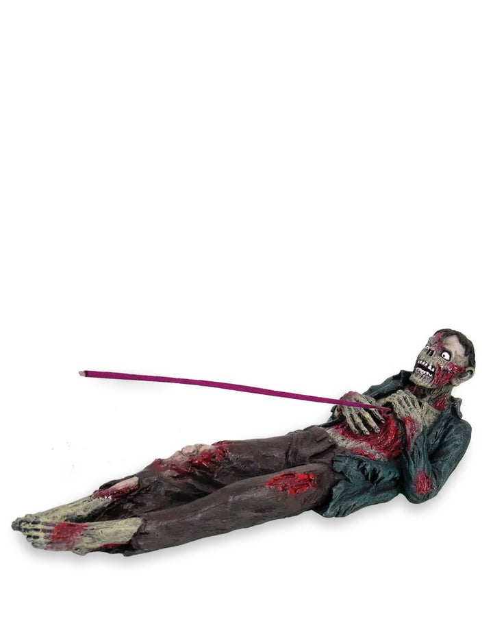 Zombie incense holder, full-length lying figure with purple incense stick and red stains