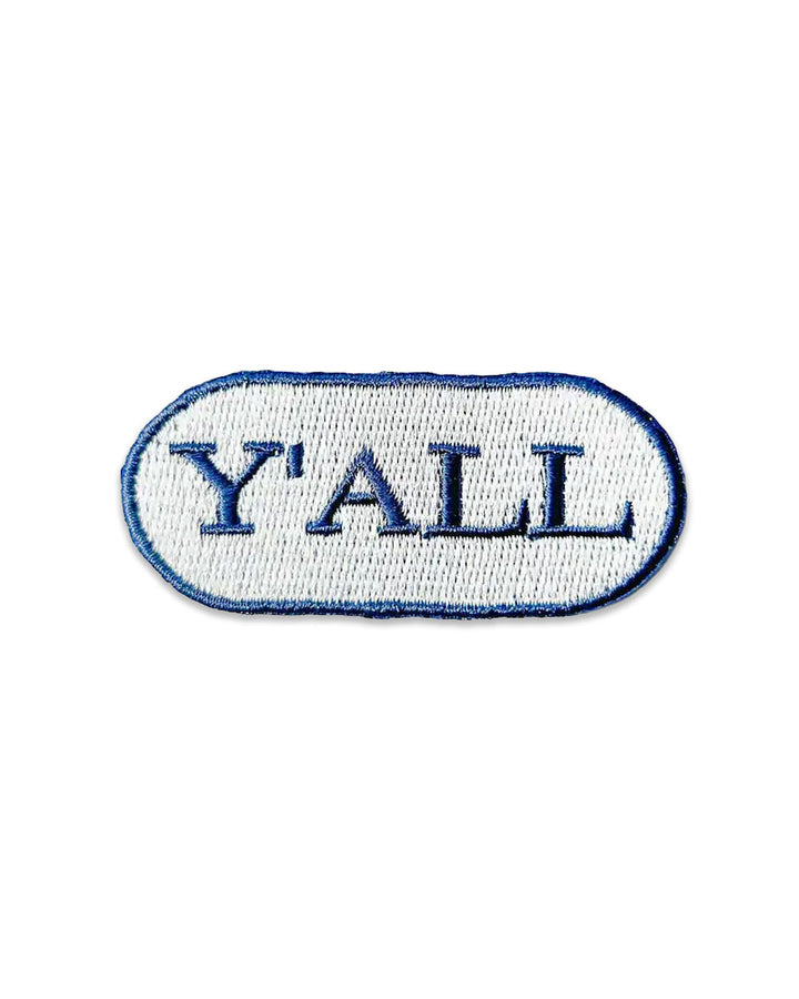 Small oval embroidered patch, light blue with 'Y'ALL' lettering