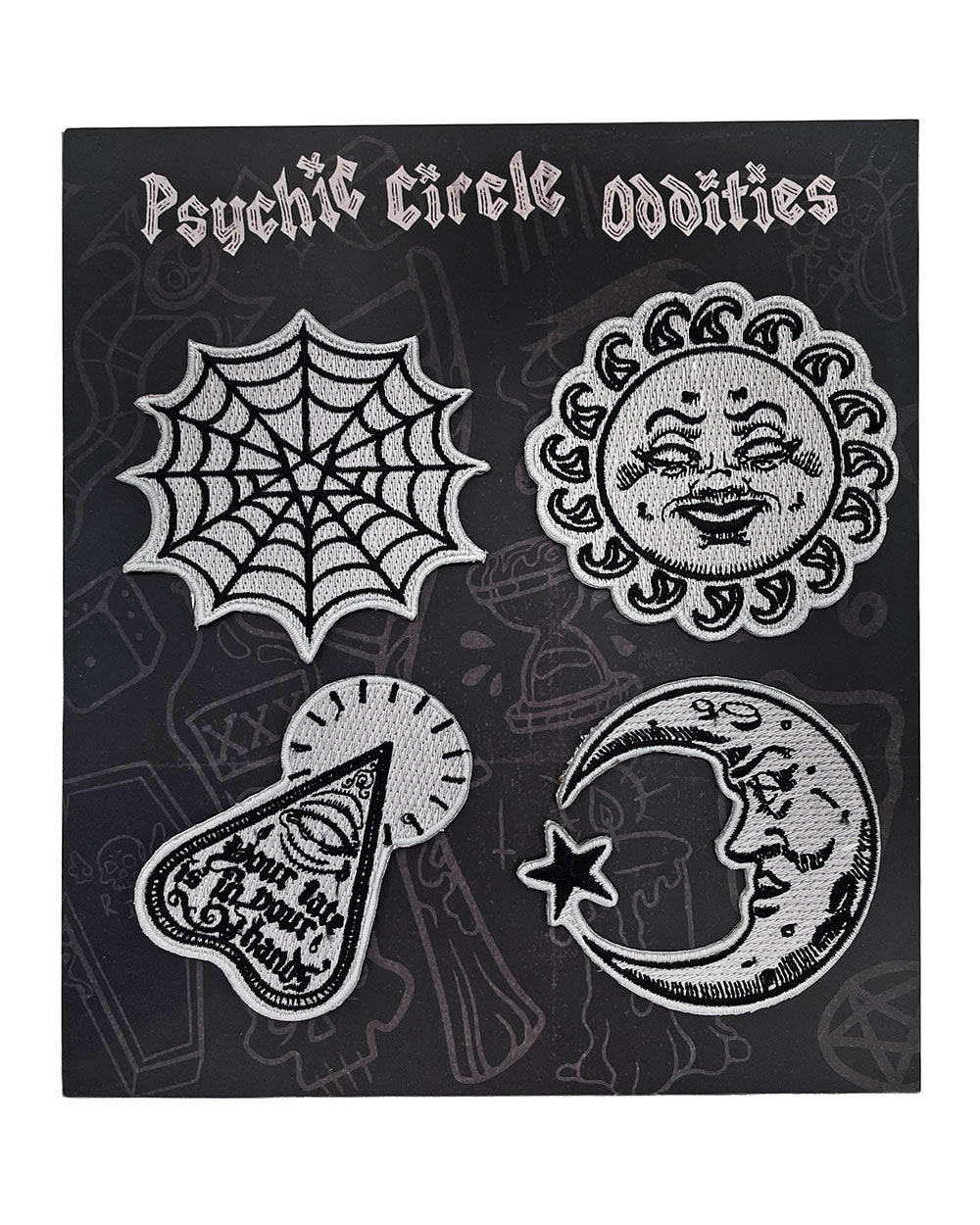 Four embroidered glow-in-the-dark patches arranged on a display card: sun, moon, web, and planchette.