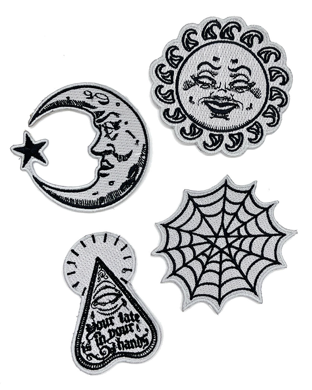 Set of four glow-in-the-dark patches: sun, crescent moon, spiderweb, and planchette designs.