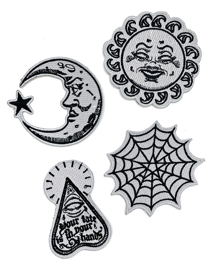 Set of four glow-in-the-dark patches: sun, crescent moon, spiderweb, and planchette designs.