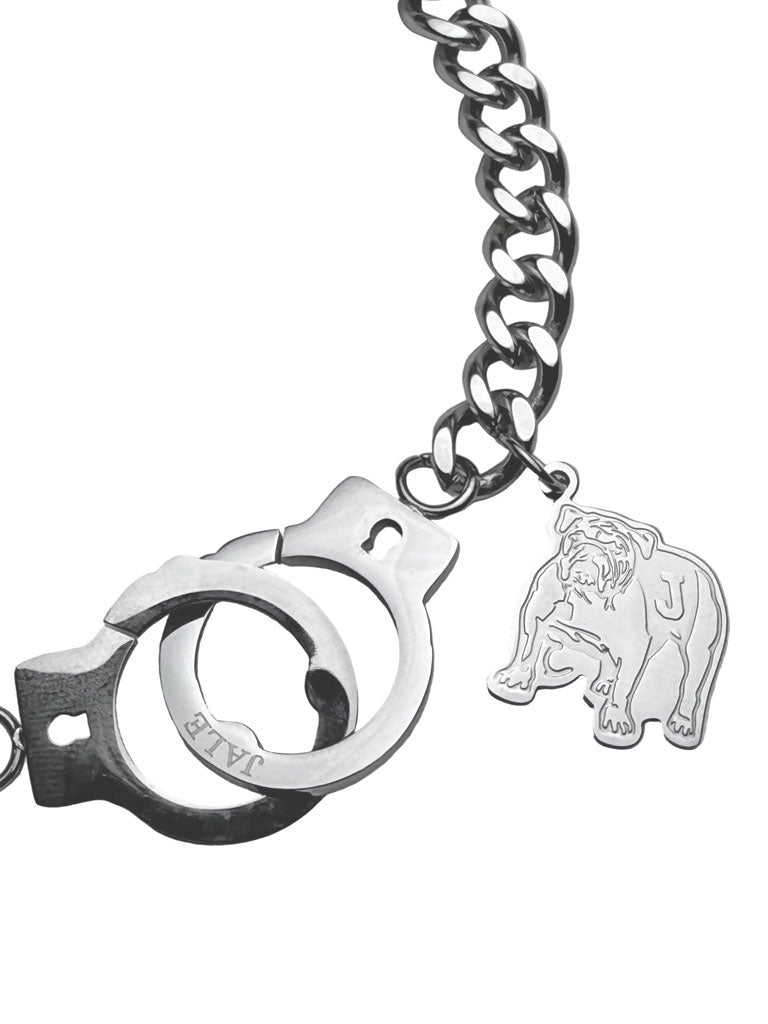 Silver handcuff bracelet close-up with link chain, cuff ring and elephant charm