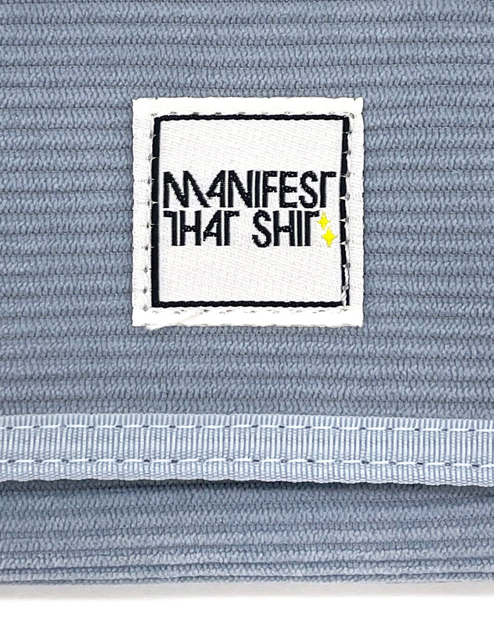 Light blue corduroy bi-fold wallet logo patch detail and textured fabric