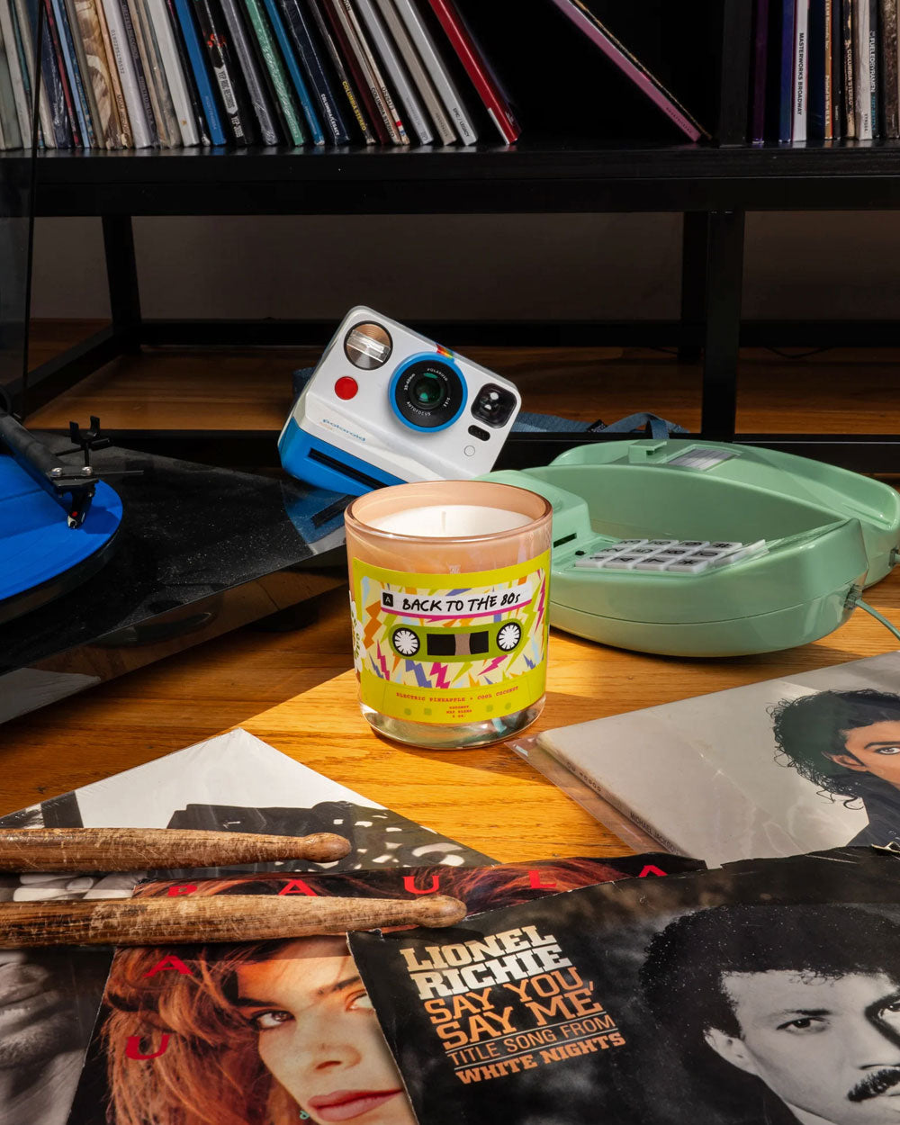 Frosted glass scented candle jar with 'Back To The 80s' retro label, lit
