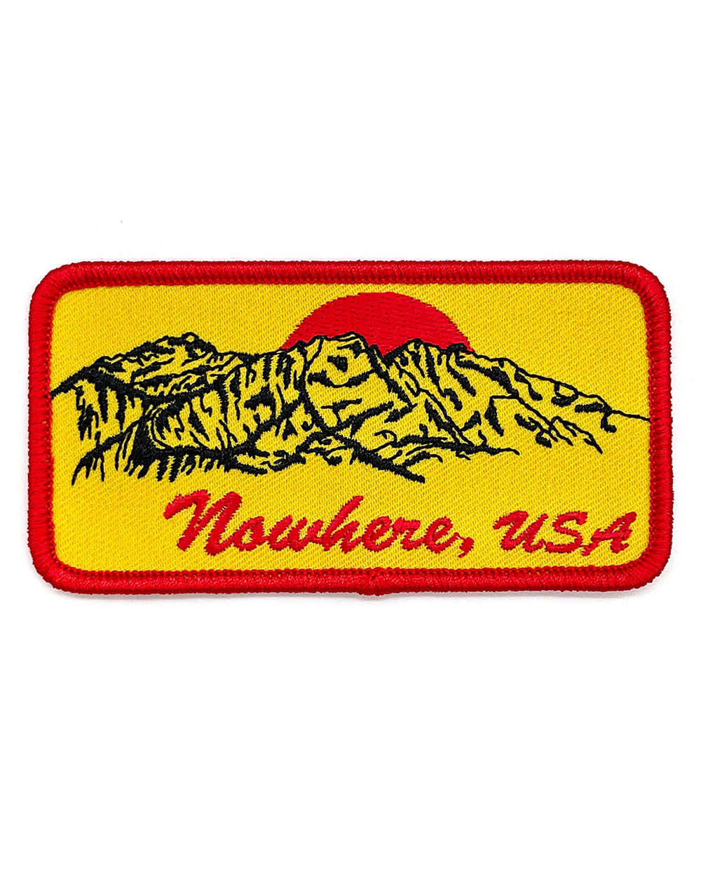 Embroidered yellow patch with red border, black mountains, and red 'Nowhere, USA' text.