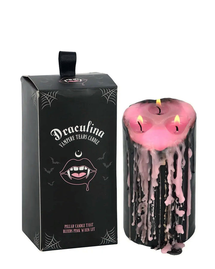 Black pillar candle with pink drip wax and themed gift box packaging