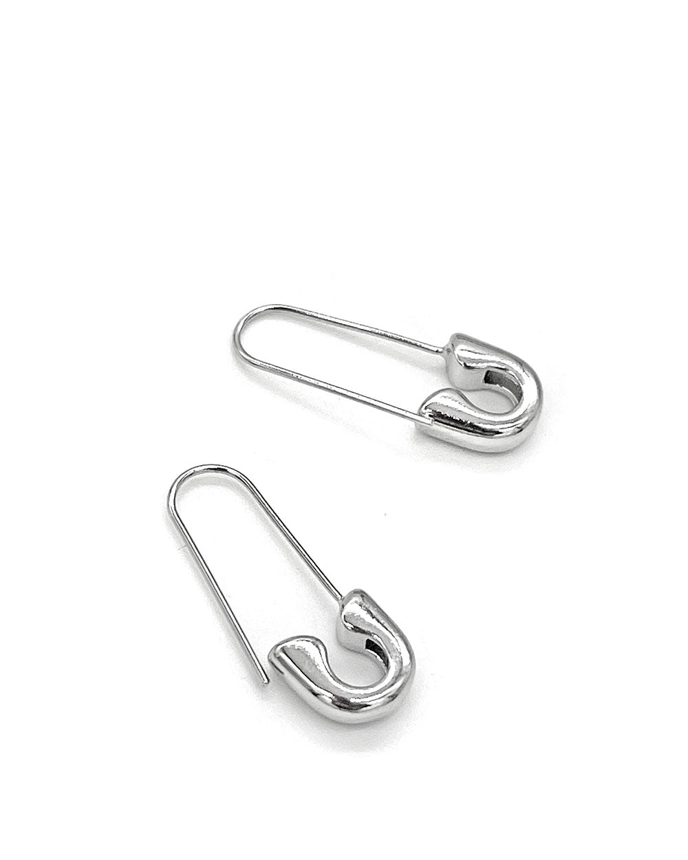 Silver safety pin earrings, angled view of two pins with clasp hooks