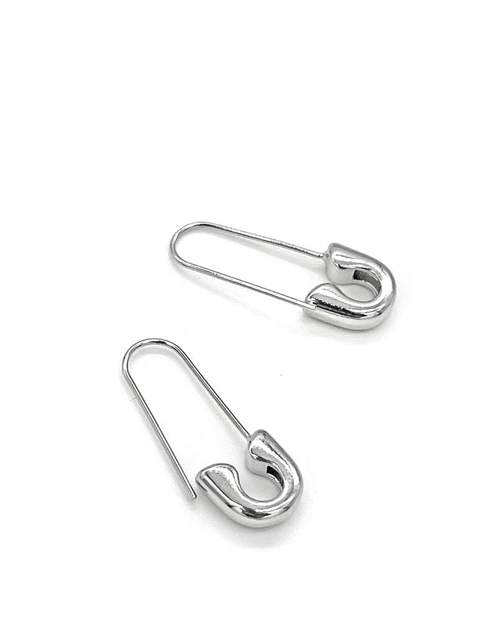 Silver safety pin earrings, angled view of two pins with clasp hooks