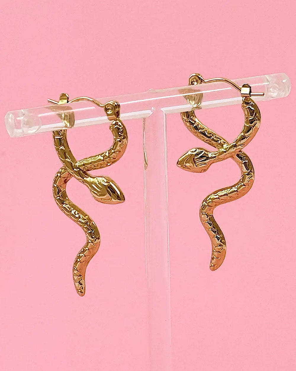 Gold serpent coil hoop earrings with snake-shaped drops and small leaf charms
