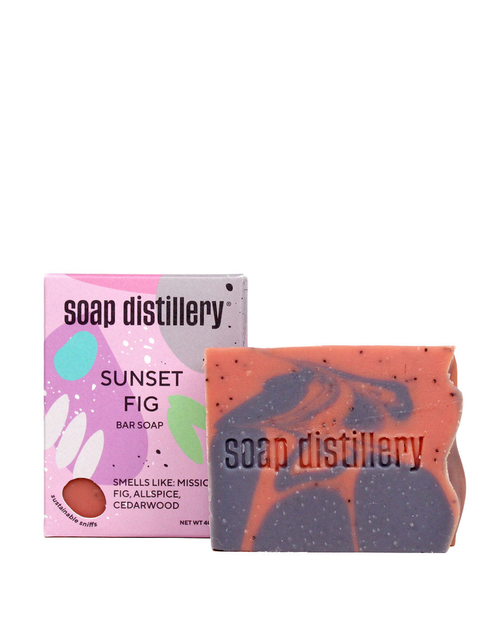 Sunset Fig bar soap box beside pink soap bar with dark swirls