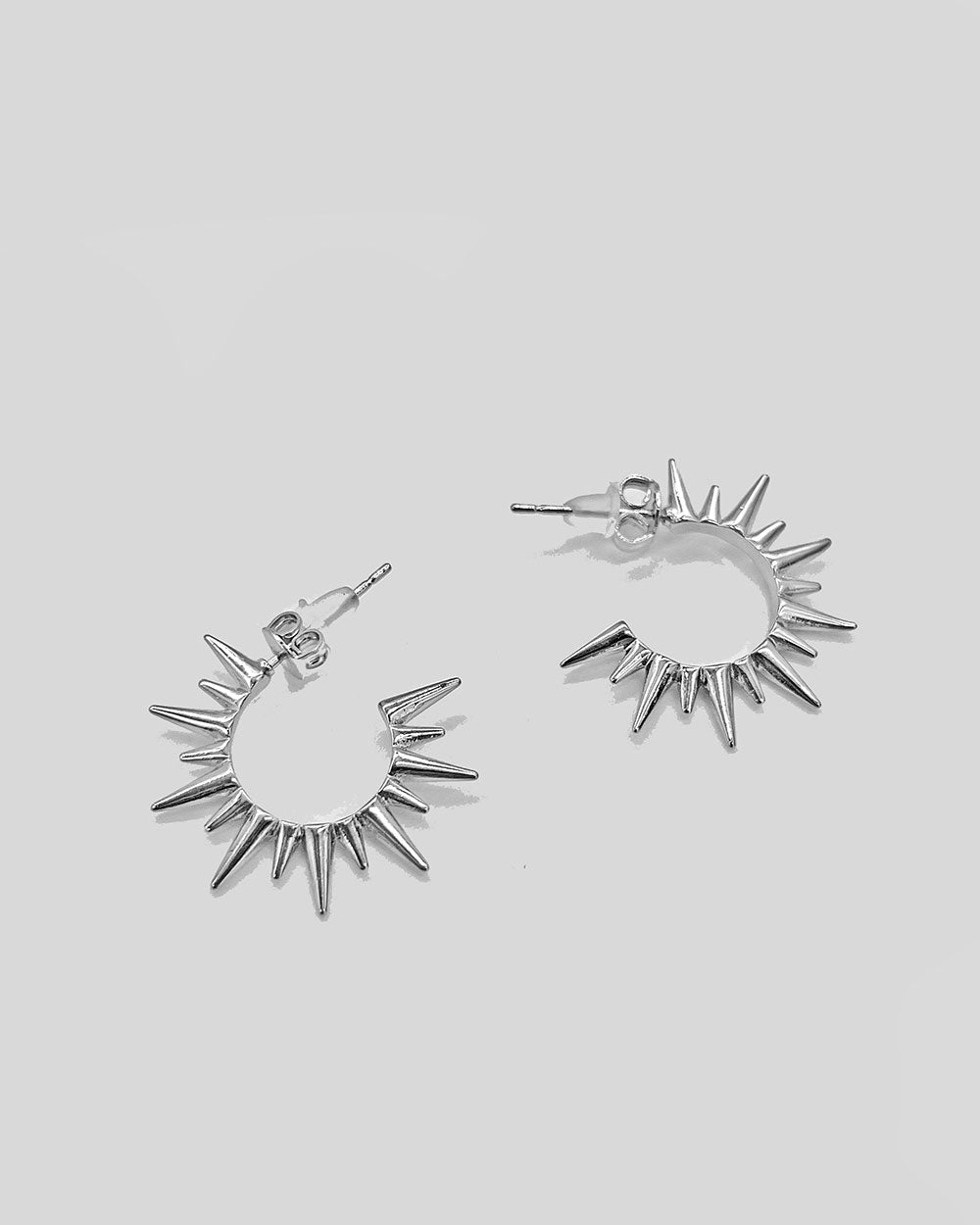 Sunburst hoop earrings in silver tone, shown from front and side angles