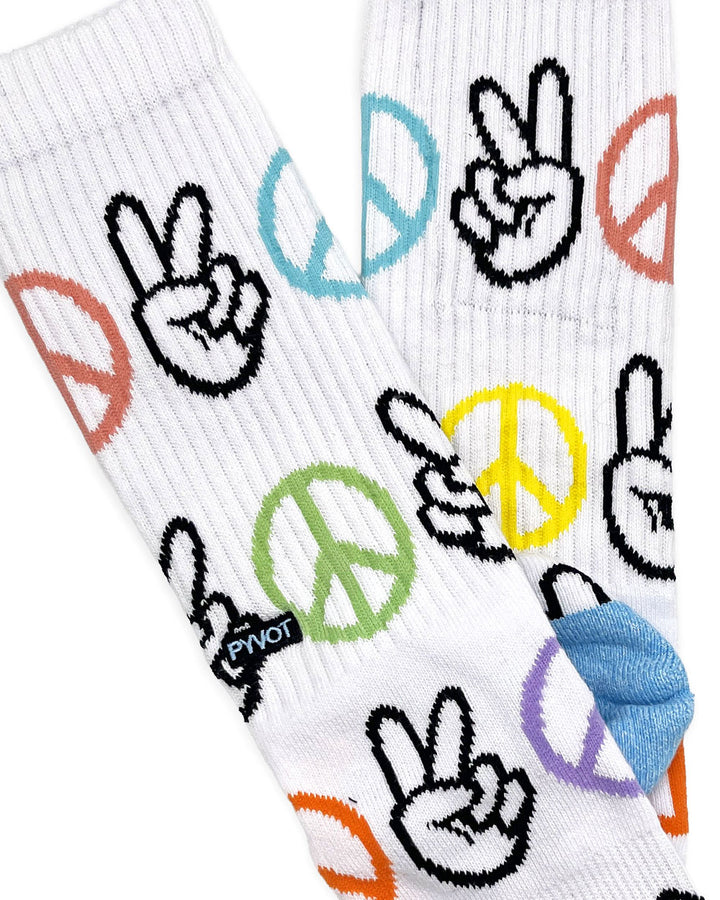 White crew socks with peace-hand and peace-sign graphics, ribbed knit close-up